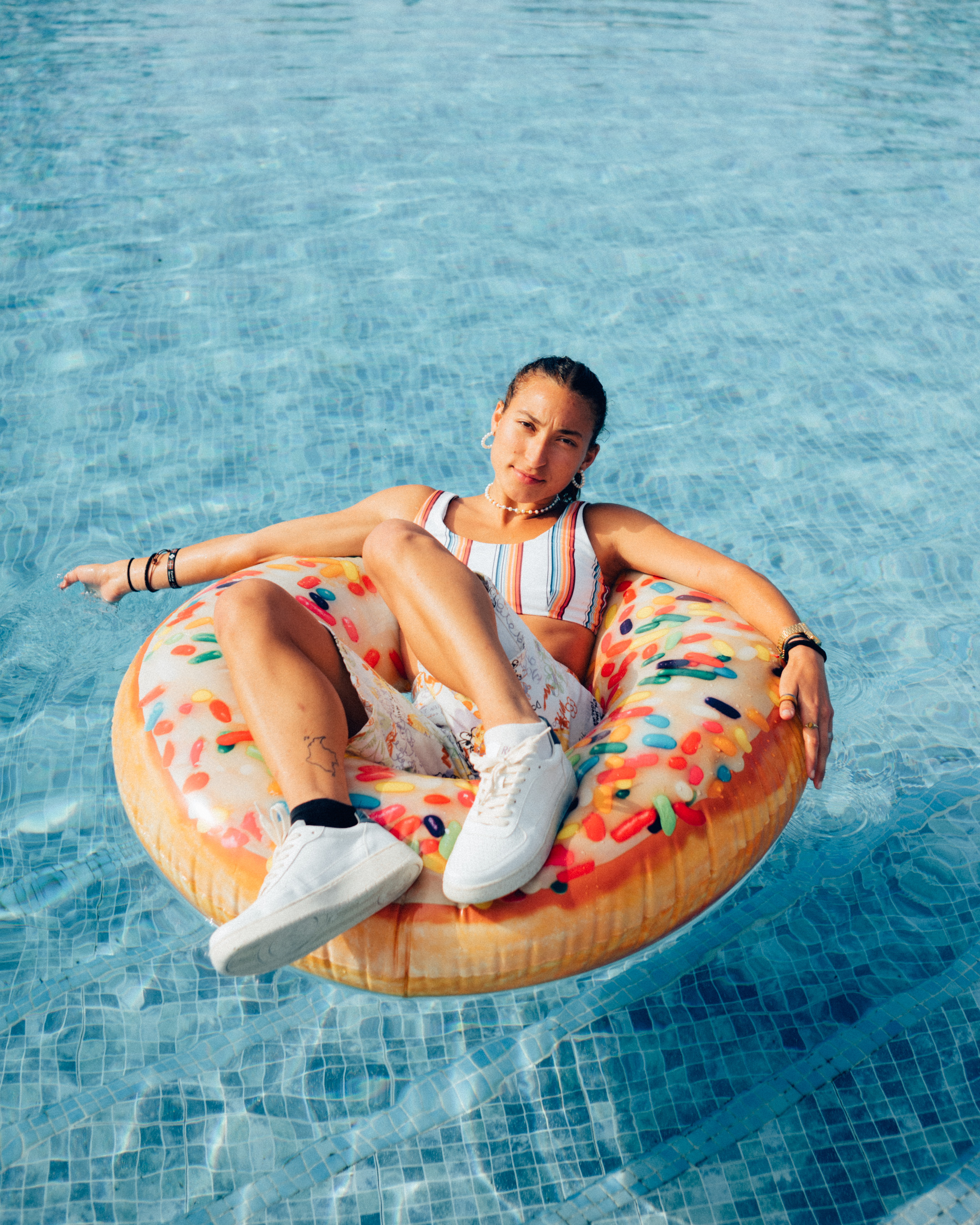 Girl with Sneaker on a swimming donut