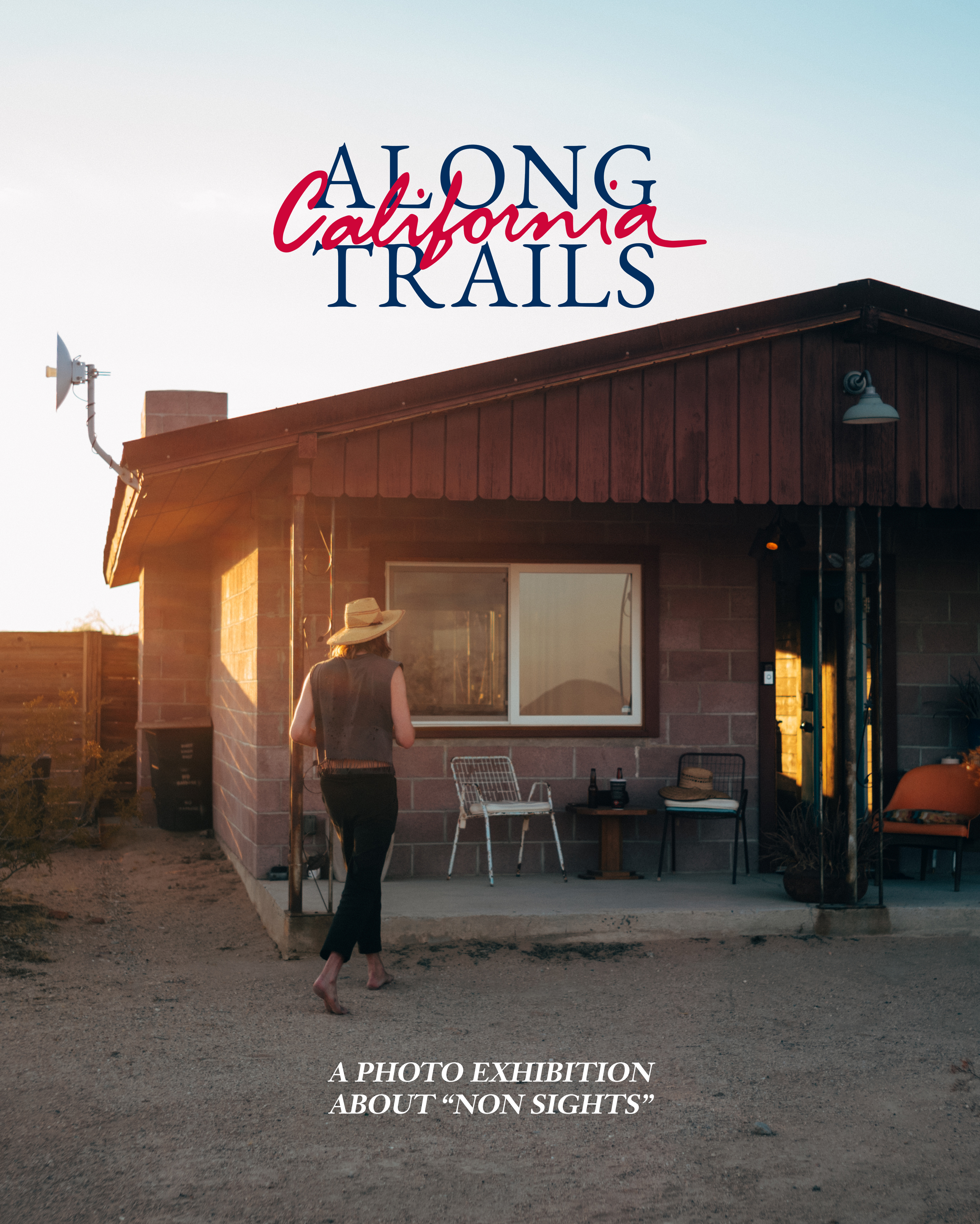 A man with a cowboy hat walking towards a house in the dessert.