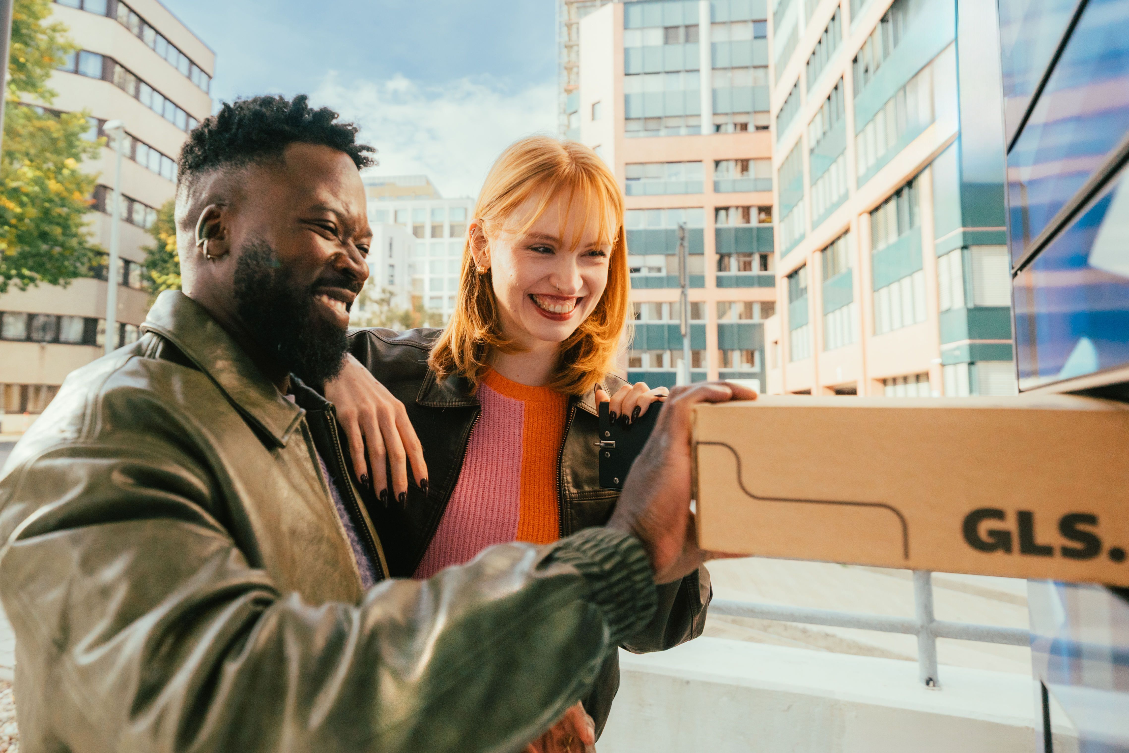 A couple puts a parcel in a locker.